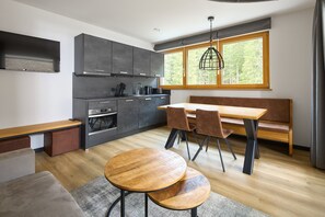 Enjoy meals in this kitchen with an oven, dining table, and comfortable seating for four.