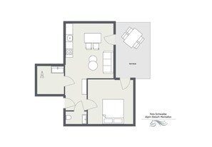 Un plan d’étage d’une chambre d’hôtel comprenant une cuisine, une terrasse et une salle de bain.