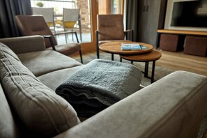 A modern living room with a sofa, armchairs, a coffee table, and a television. - 59201 Alpen-Dohle 201 T (Gargellen)
