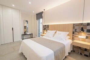 Ein modernes Schlafzimmer mit einem großen Bett, Nachttischen, einem Spiegel und einem Kleiderschrank.