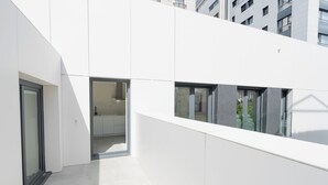 A modern building with a clean, white exterior and large windows.