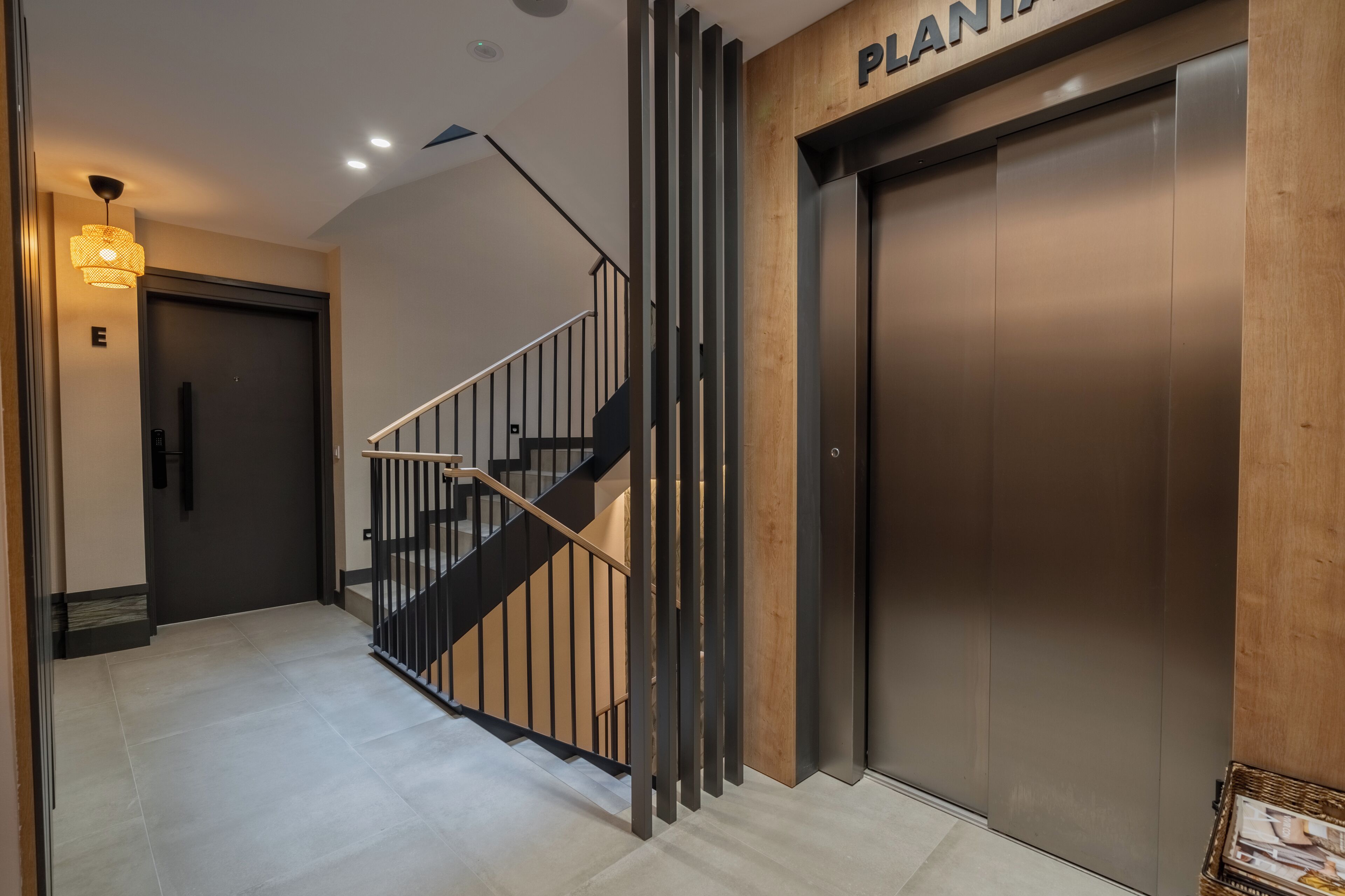 A modern elevator with a wooden panel and a sign above it.