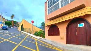 A building with a sign reading "LASSIETTE ISLAS" and a red door. - Guest House la 7 islas, Red Room (Adeje)