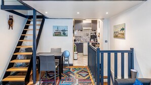 En modern lägenhet med ett sovrum i loftstil, ett matområde och ett kök.