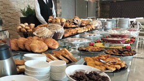 A buffet with various food items including pastries, bread, and desserts. - Grand Plaza Hotel (Kirdasah)