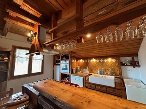 A wooden kitchen with a central island, a microwave, a stove, and a sink. - 2nd floor, 70m², Vars (Vars)