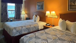A hotel room with two beds, a nightstand with a phone, a lamp, and a window with curtains. - Motel 6 Morrilton, AR (Morrilton)