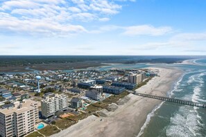 A coastal town with beachfront properties, a pier, and a clear view of the ocean. - Oceanfront Delight - Indoor Pool, Sleeps 4 (North Myrtle Beach)
