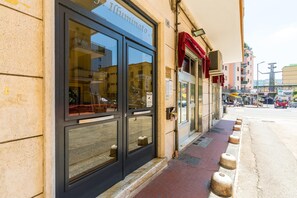 A storefront with large glass windows and a red awning. - Alehouse at Napoli Expo (Naples)