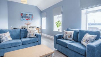 Apartment (2 Bedrooms) | Living area | 32-inch Smart TV with cable channels