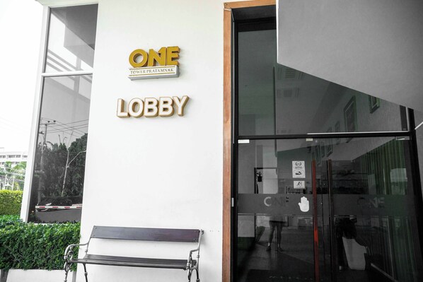 A building entrance with a sign reading "ONE TOWER PRATAMNAK LOBBY". - One Tower apartments by Apartwell (Pattaya)
