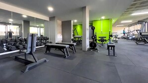 A modern gym with various exercise equipment, including benches, dumbbells, and weight machines. - Tilal Fanar Resort, Pools, Generator Included (Ain Saadeh)