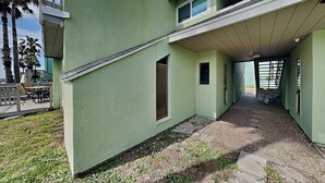 A modern two-story building with a flat roof and large windows. - Coastal Cozy and a View by Silver Sands Vacation Rentals (Corpus Christi)