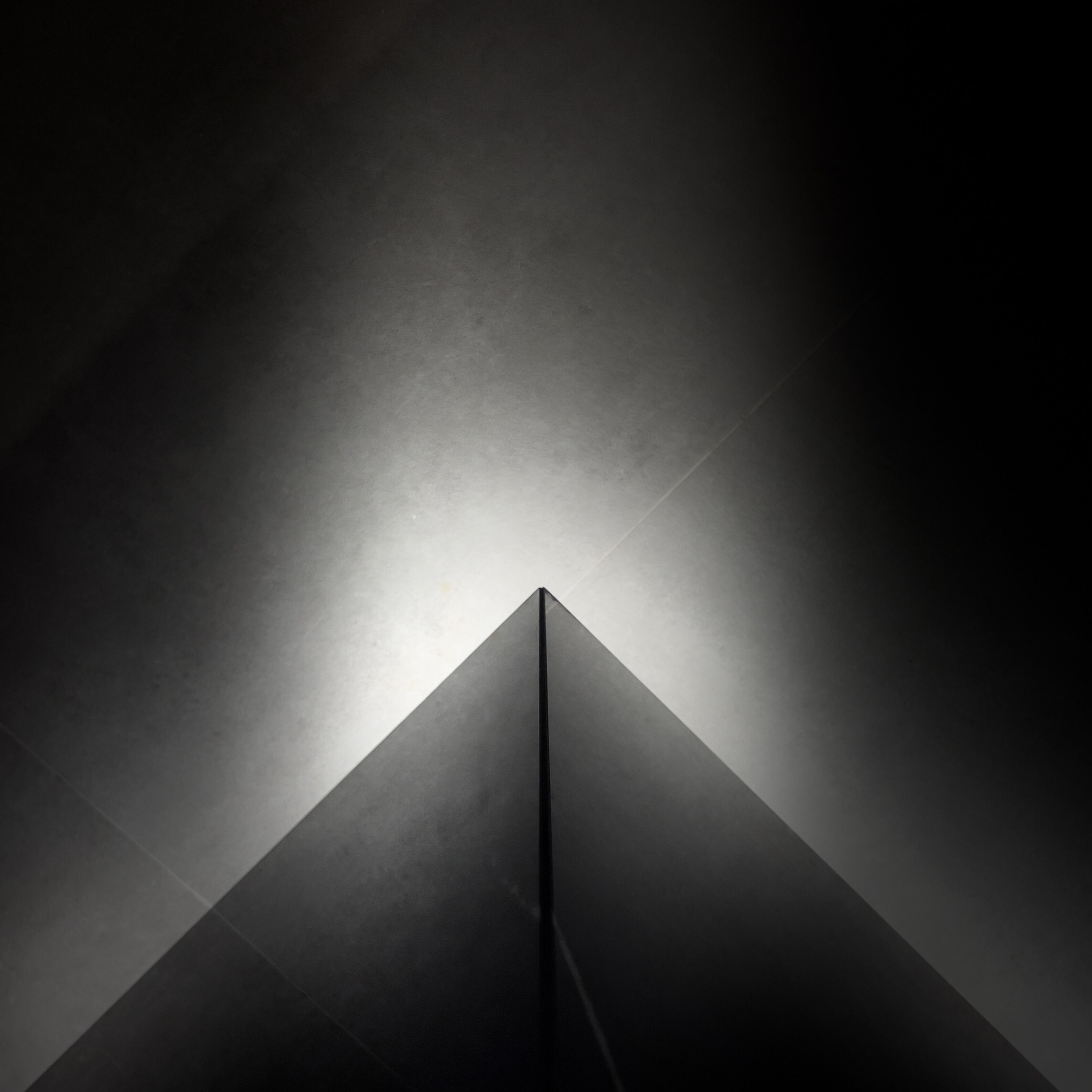 A geometric structure with a central light source.