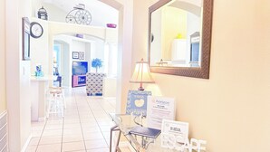 A hotel reception area with a glass desk, a welcome sign, and a no vaping, no smoking sign. - EP1051SEL - Private Vacation Pool Home Near Disney (Kissimmee)