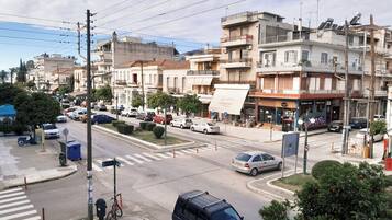 A street view with buildings, cars, and a crosswalk.