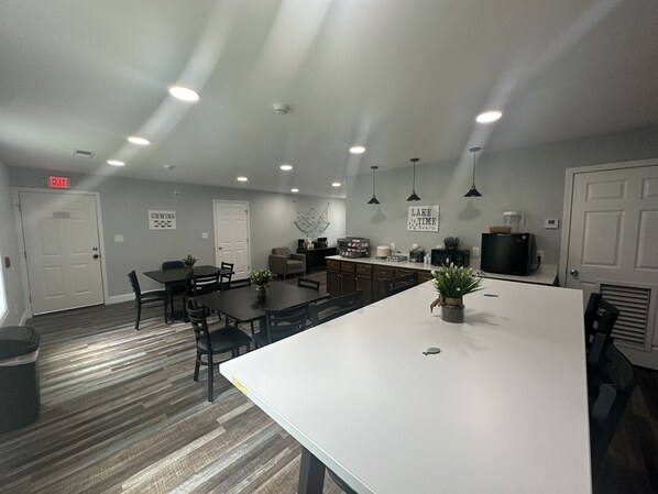 A modern kitchen with a central island, built-in appliances, and pendant lighting.