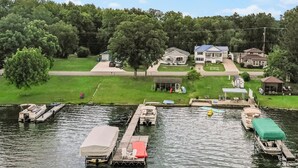 A lakeside property with docked boats, a covered boat, and a gazebo. - Beautiful 6 bedroom lake house. Pontoon available for rent (Union)
