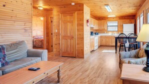 A wooden cabin interior with a living area, kitchen, and dining space. - Chalet with 2 Bedrooms lakeside to Dale Hollow Lake #17 (Byrdstown)