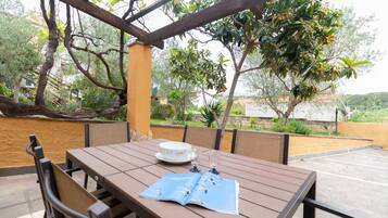 Enjoy a romantic meal for two on the patio, surrounded by lush trees and a scenic view.