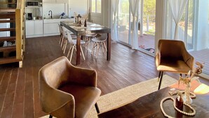 A spacious kitchen with white cabinets and a wooden ceiling. - A Spacious Ocean View Villa, steps away from Punta Cocos bioluminescence beach.  (Holbox)