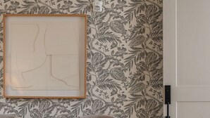 A bedroom with a bed, a chair, a rug, and a door. - Luxury Downtown Loft (Athens)