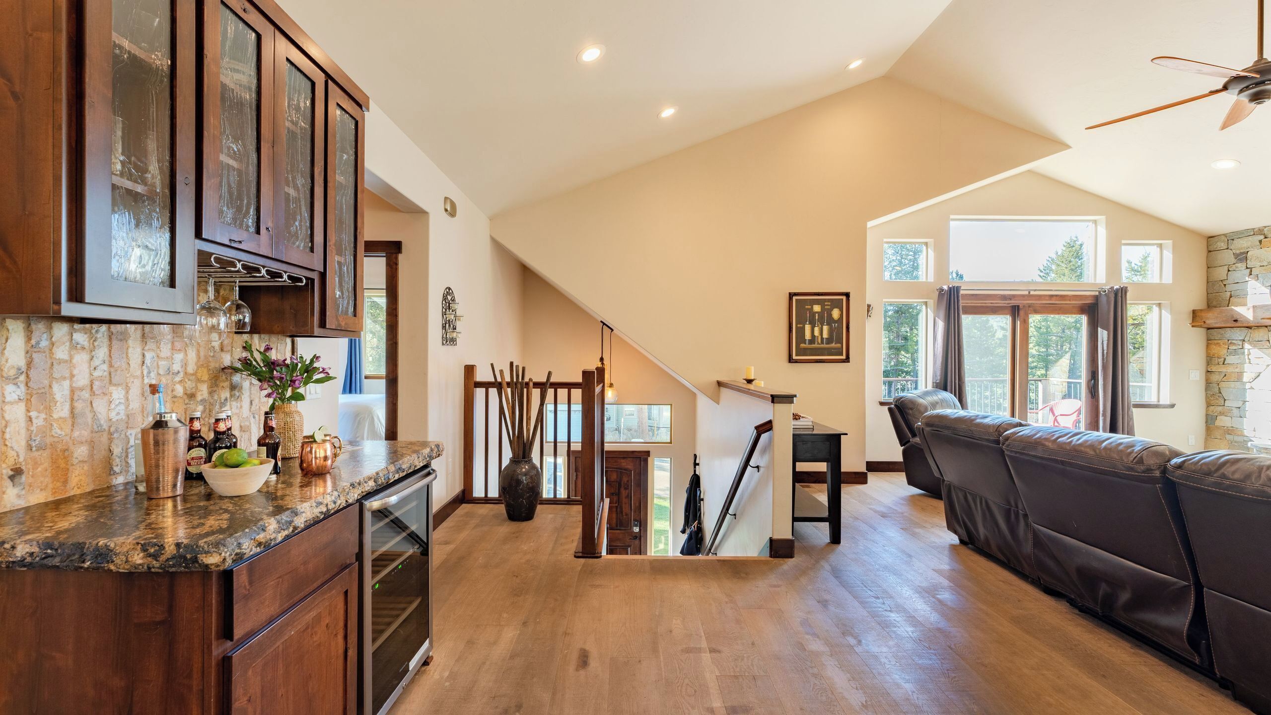 A spacious kitchen with wooden cabinets, a granite countertop, and a built-in oven.
