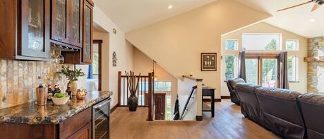 A spacious kitchen with wooden cabinets, a granite countertop, and a built-in oven.