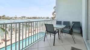 A balcony with a view of a marina and a swimming pool. - Waterfront 4-level Townhome with Rooftop Deck! (Clearwater Beach)