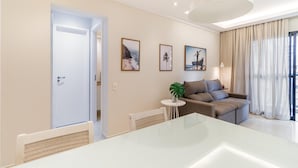A modern living room with a sofa, a dining table, and a large window with curtains. - Ai78-902 in S o Paulo (São Paulo)