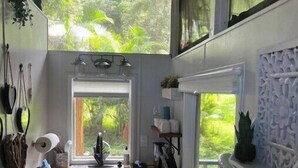 Una cocina compacta con ventana, lavamanos y una pequeña isla.