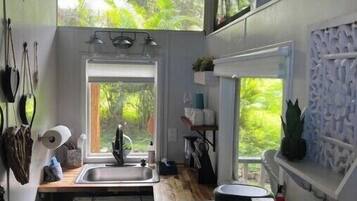 Fridge, microwave, coffee/tea maker, cookware/dishes/utensils