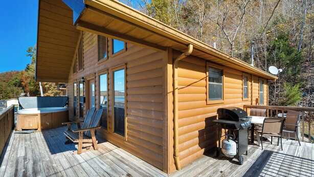 A wooden cabin with a deck, a hot tub, and a grill. - 2 Bed Chalet Lakeside with Exceptional View of Dale Hollow Lake  (Byrdstown)
