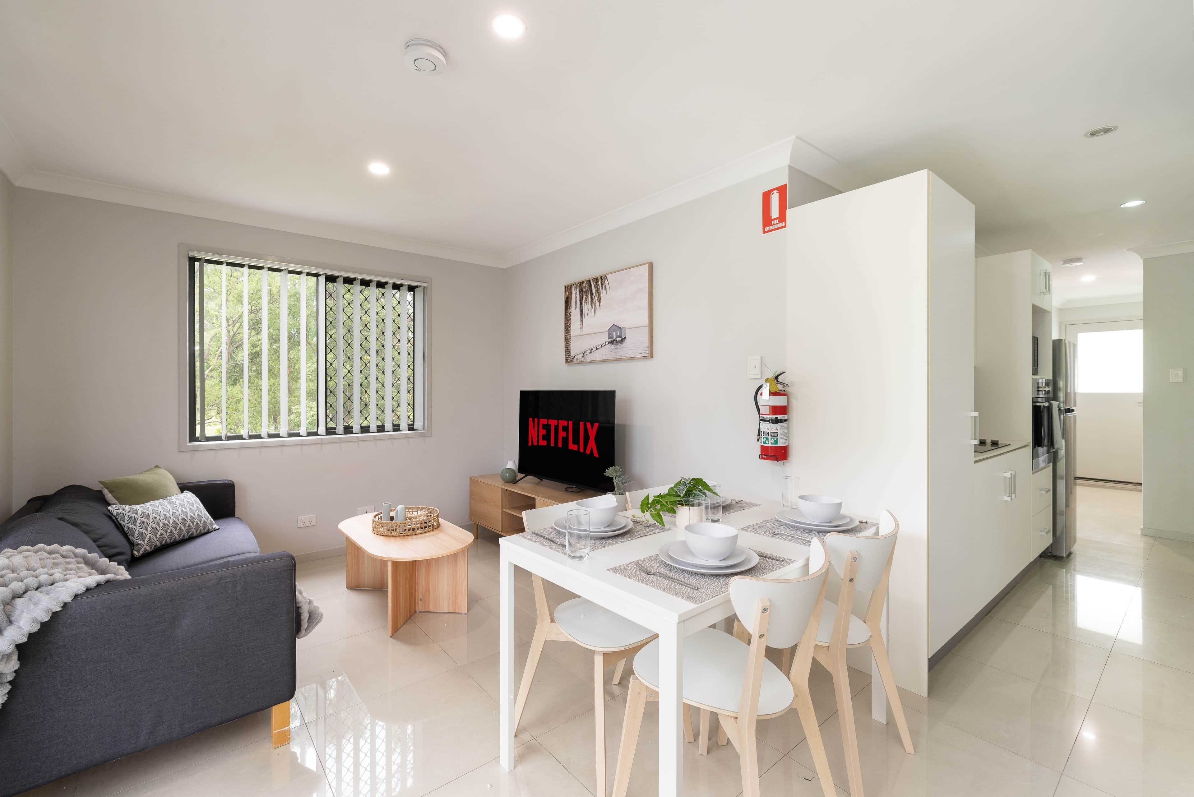 Living Area: Bright living space with comfortable seating and TV 