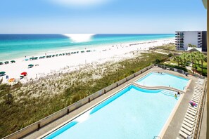 A pool adjacent to a beach with a view of the ocean. - Waters Edge 613 • Top Floor Beach Gem, Perfect Views, Luxury Condo, Pool, Covered Parking (Fort Walton Beach)