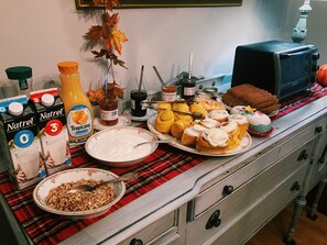 Enjoy a hearty breakfast with a selection of pastries, cereal, and fresh condiments.