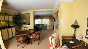 A dining area with a round table and chairs, a sofa, and a lamp. - Keyah Grande - South Pacific (Pagosa Springs)