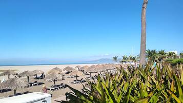 On the beach, sun loungers, beach towels