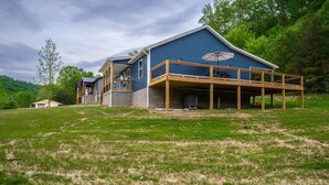 A large blue house with a wooden deck and a covered outdoor area. - Red River Gorge, Hollerwood Stays! High Speed Wi-Fi, Pet-Friendly! New Home! (Clay City)