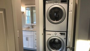 A laundry room with two stacked front-loading washing machines.