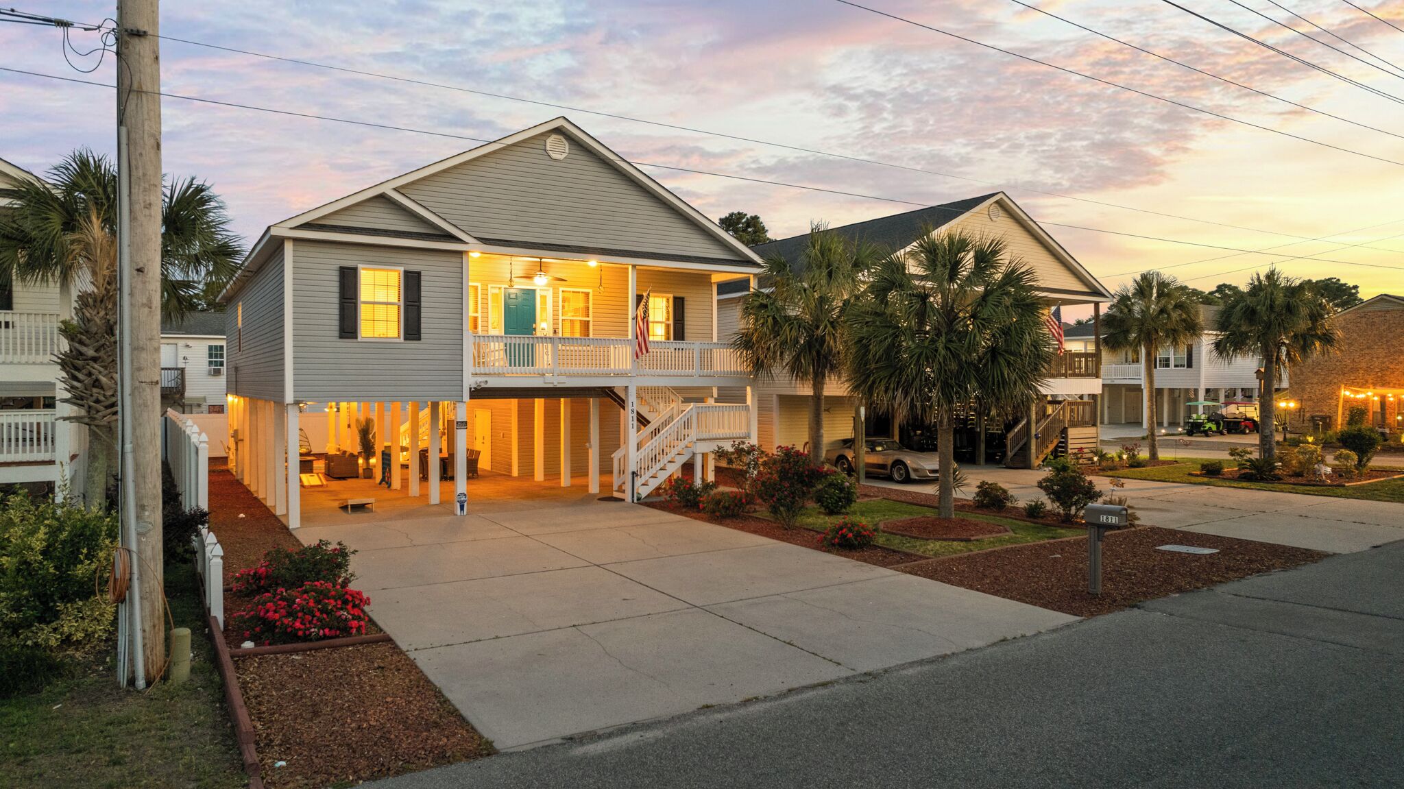 A two-story house with a balcony, a covered front porch, and a driveway.