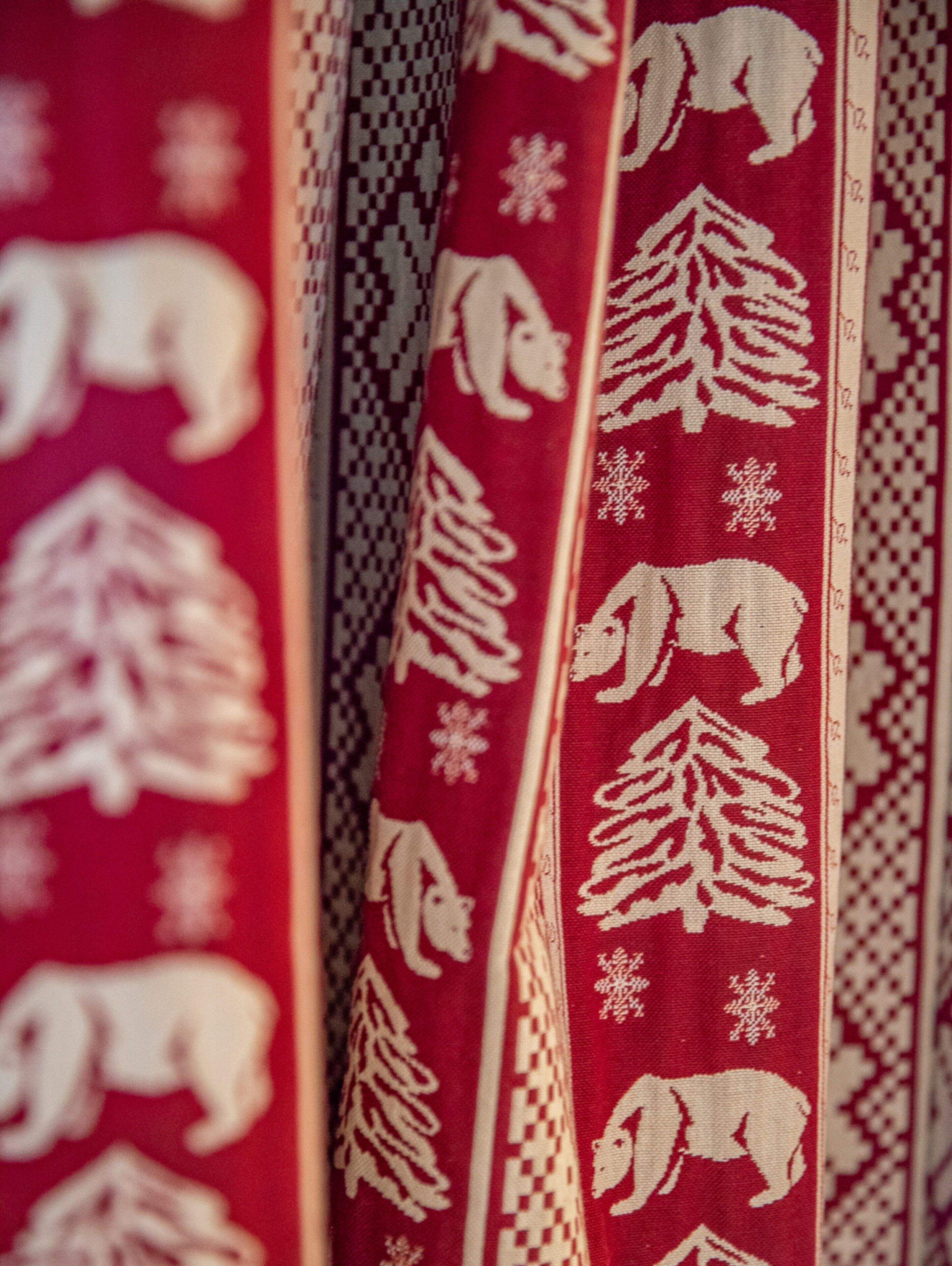 A close-up of a patterned fabric with animal and tree designs.