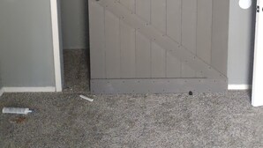 A closed sliding door in a room with a speckled floor and a white door frame. - Serenity's Sanctuary in this quiet, peaceful 2 bdr 1 bath bungalow. Pet friendly (Cushing)