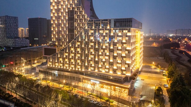 A modern building with a grid-like facade, large windows, and a prominent entrance. - Crystal Orange Hotel Nanjing Southeast University (Nanjing)