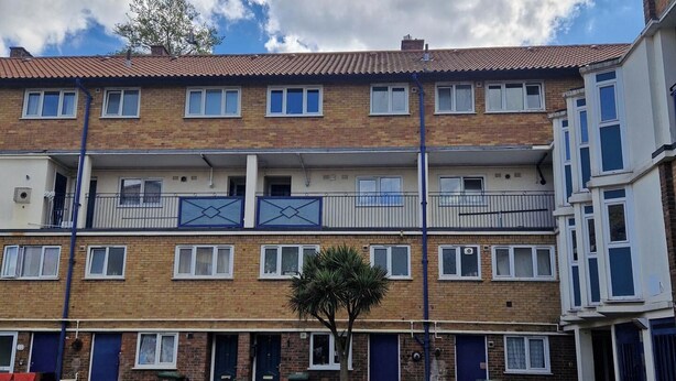 A multi-story residential building with a brick facade, multiple windows, and balconies. - 2 Bed-Sleeps5-Free Parking-10 min Walk underground (London)