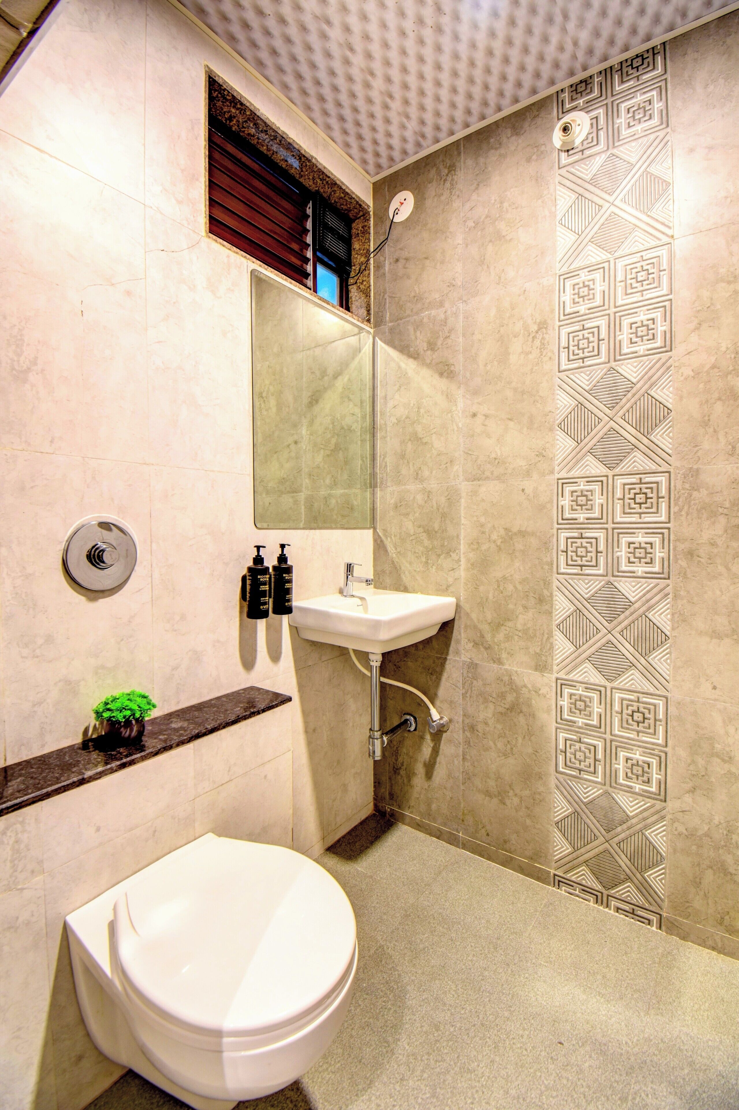 A bathroom with a toilet, sink, and shower.