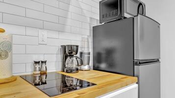 Fridge, microwave, coffee/tea maker, cookware/dishes/utensils