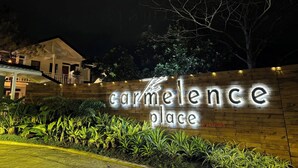 A sign for 'Carmelence Place' with a wooden facade and illuminated letters. - The carmelence place by cerilos (Tagaytay)