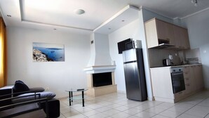 A modern kitchen with a built-in oven, microwave, and a stainless steel refrigerator.