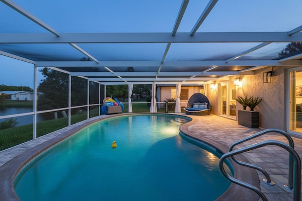 Outdoor swimming pool in screened lanai